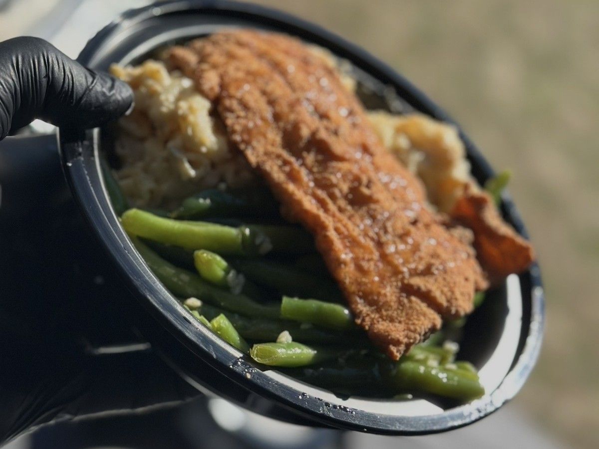 Fried fish plate with rice, mac and cheese, green beans and candied yams