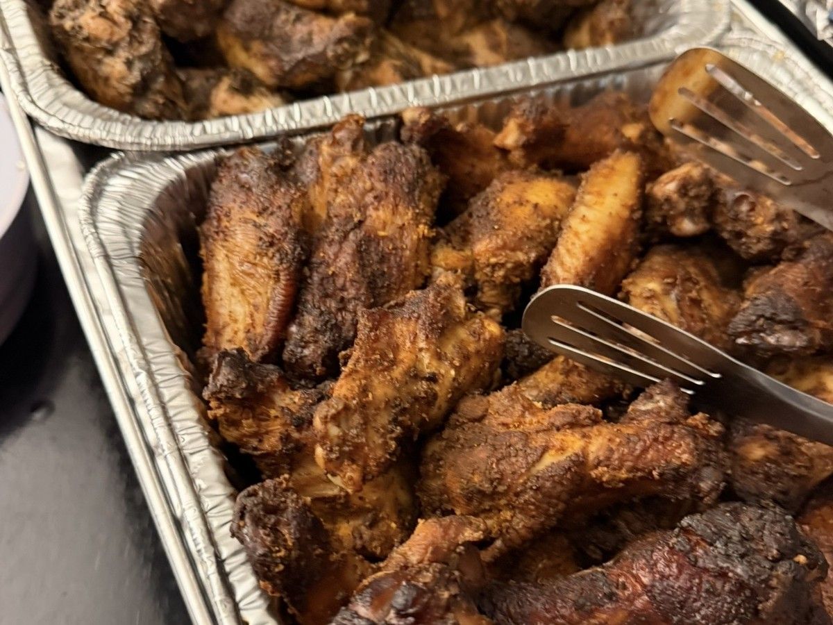 Trays of seasoned smoked chicken wings